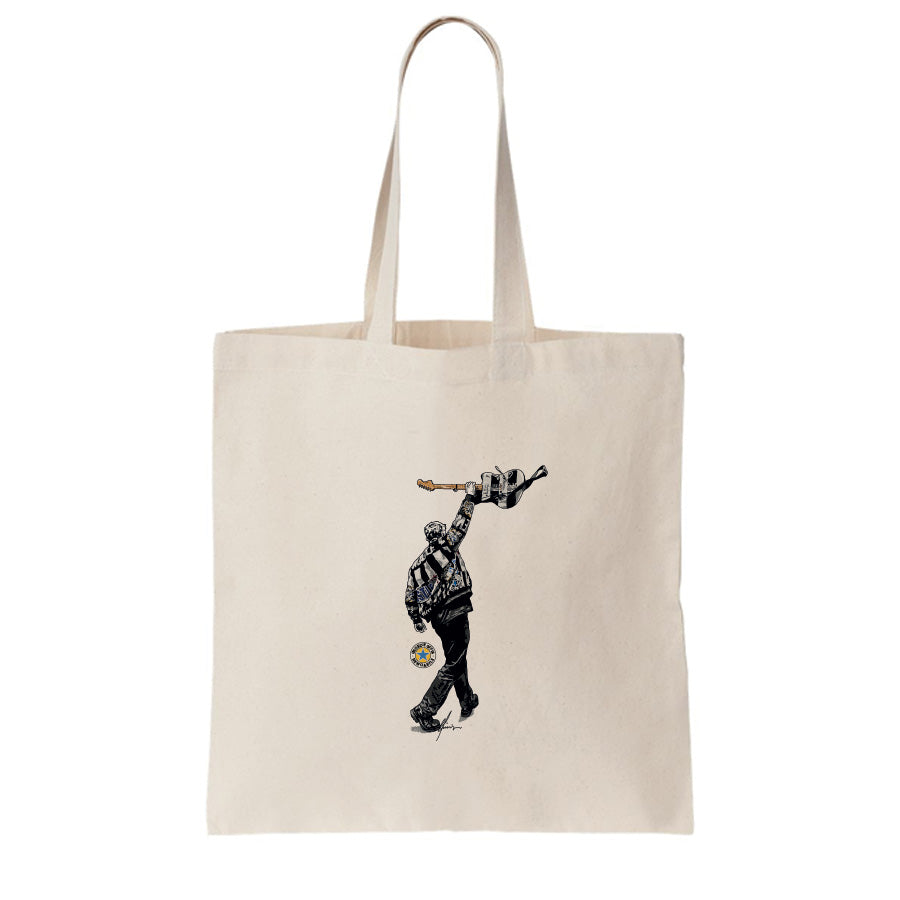 Geordie Gifts natural cotton tote bag featuring Sam Fender illustration with black and white guitar raised at St James’ Park 2025.