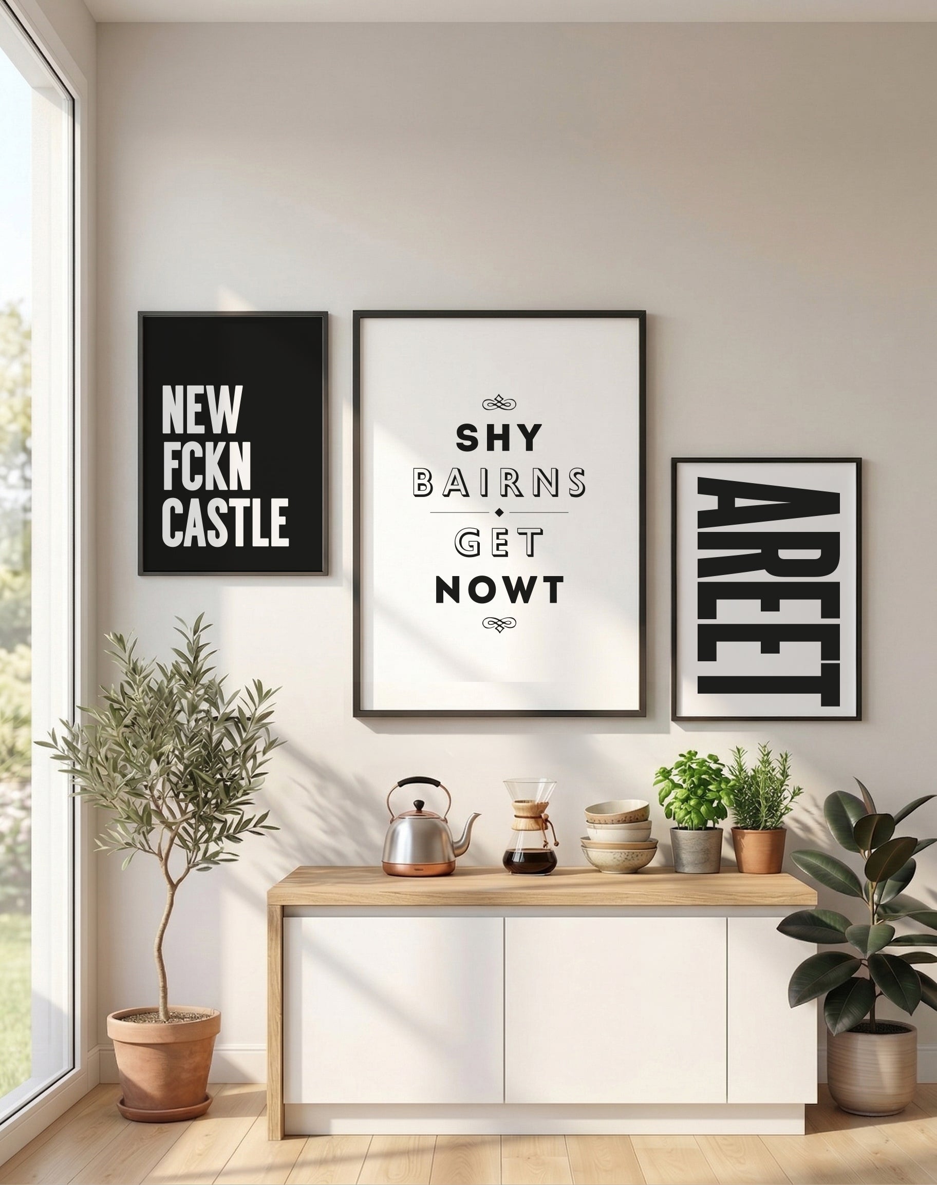 A white 'Shy Bairns Get Nowt' print featured on a gallery wall alongside 'Areet' and 'New Fckn Castle' posters. designed by geordie gifts