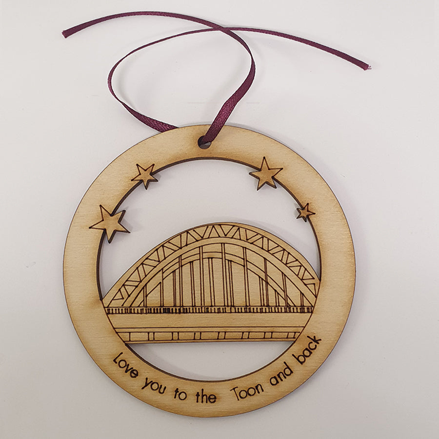 Unique High Quality Lazer Cut Geordie Christmas Tree Decoration Baubles Bauble displays: Etched illustration of the Tyne Bridge alongside the text 'Love you to the Toon and back'. by geordie gifts and craft sensations
