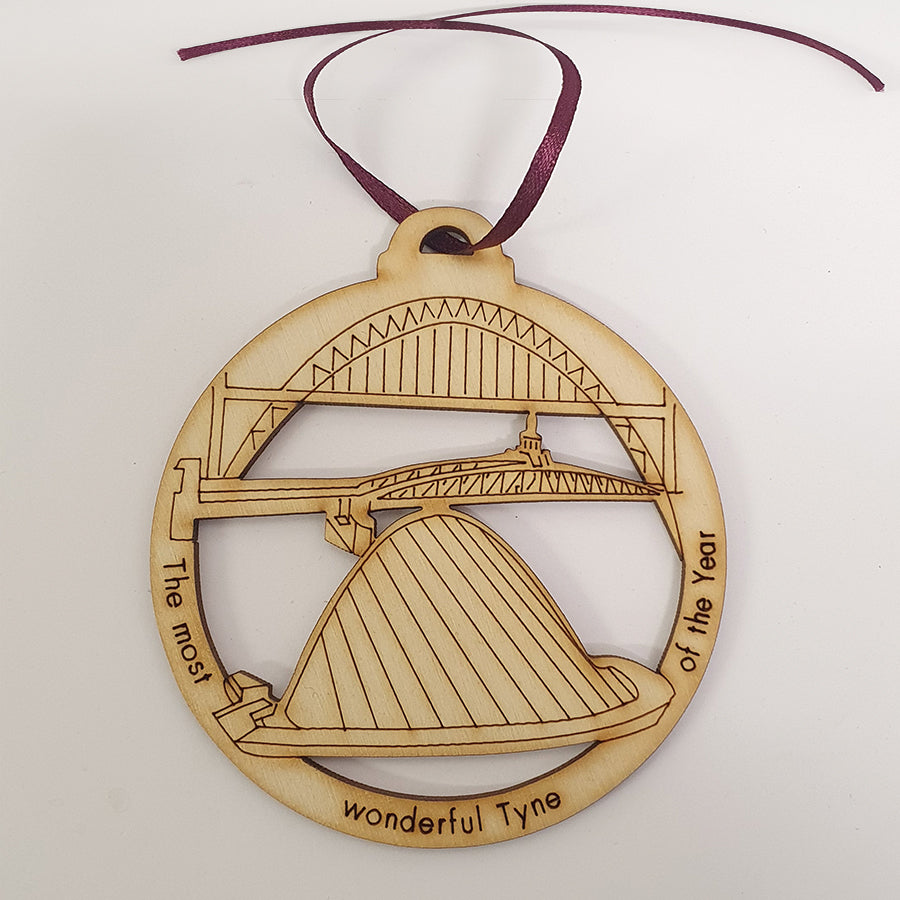 Unique High Quality Lazer Cut Geordie Christmas Tree Decoration Baubles Bauble displays: Etched illustrations of the Tyne Bridge, Swing Bridge & millennium bridge alongside the text 'The most wonderful Tyne of the year' by craft sensations and geordie gifts