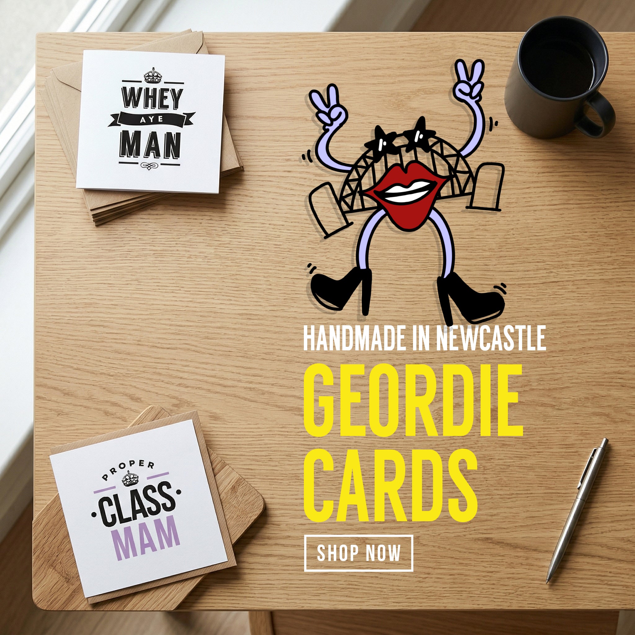 Geordie Gifts homepage banner promoting 'Handmade in Newcastle Geordie Cards'. The overhead view of a wooden desk shows a black coffee mug, a silver pen, and two square greeting cards reading 'Whey Aye Man' and 'Proper Class Mam'. The graphic features a sassy cartoon Tyne Bridge mascot wearing star-shaped sunglasses, large red lips, and high heels, throwing double peace signs.