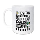 Geordie Gifts Newcastle United supporter mug featuring a hand-drawn Dan Burn illustration with the Carabao Cup trophy and the fan chant ‘He’s from Blyth, you’ll never ever beat Dan Burn