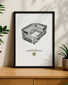 A minimalist black-framed illustration of the Newcastle United football ground sitting on a wooden sideboard.