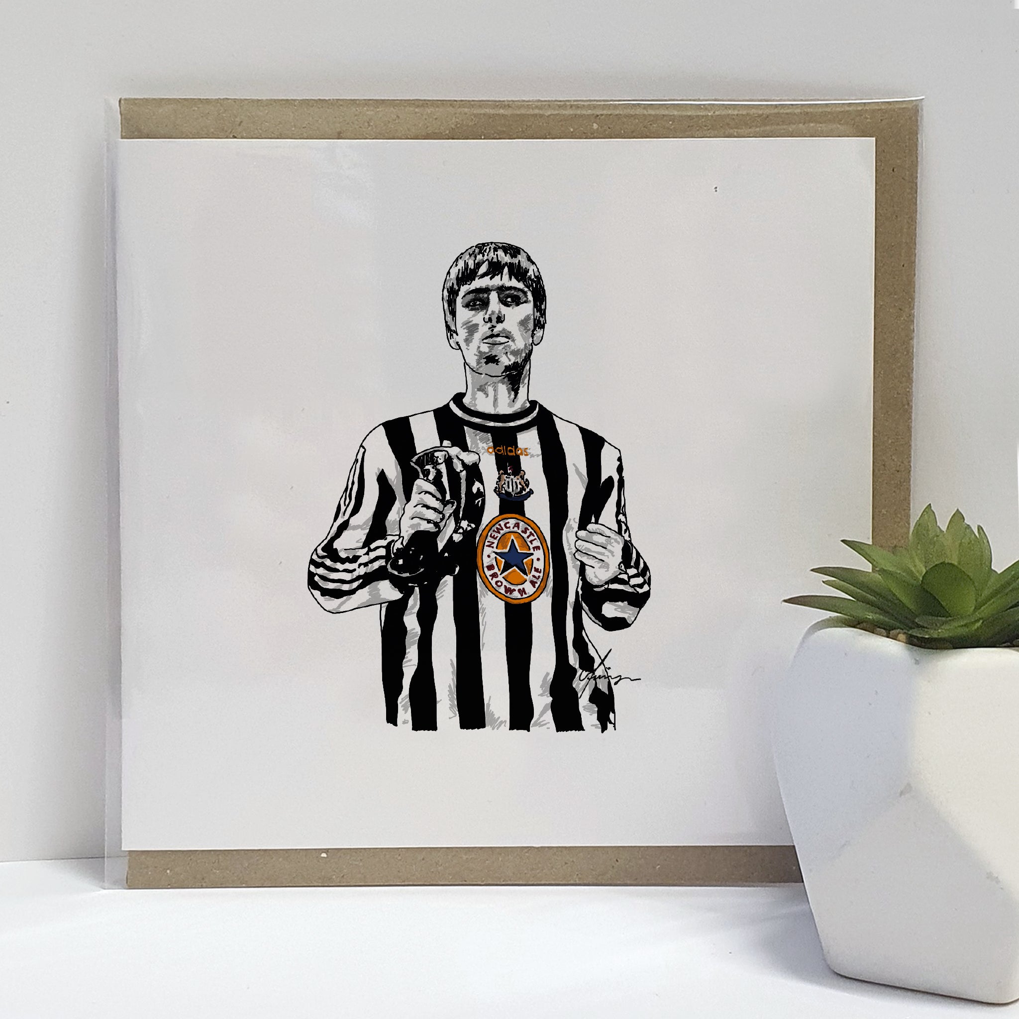Greeting card featuring a hand-drawn illustration of Liam Gallagher wearing a Newcastle United shirt, commemorating the night he wore it at a gig coinciding with Newcastle's match against Barcelona 1997, designed on high-quality card stock.