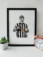 Liam Gallagher in Newcastle United Shirt Oasis Gig Artwork by geordie gifts, featuring an illustration of Gallagher wearing a Newcastle United shirt in a black frame.