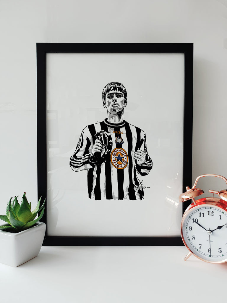 Liam Gallagher in Newcastle United Shirt Oasis Gig Artwork by geordie gifts, featuring an illustration of Gallagher wearing a Newcastle United shirt in a black frame.