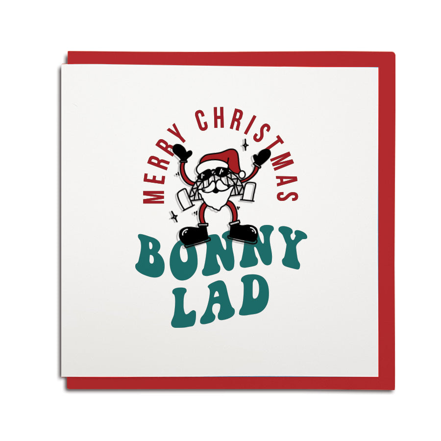 Funny Geordie Christmas card by Geordie Gifts featuring Santa as the Tyne Bridge with the text "Merry Christmas Bonny Lad."