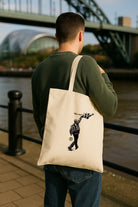 sam fender black and white guitar st ajmes park stadium gig 2025 geordie gifts official merchandise tote bag on a man in front of the tyne bridge on newcastle quayside by the river tyne