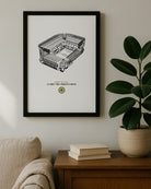 The "Howay The Lads" St. James' Park stadium drawing hanging on a neutral wall next to a houseplant.