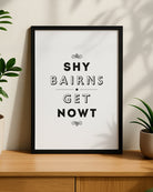 A minimalist white 'Shy Bairns Get Nowt' Newcastle dialect print in a black frame designed by geordie gifts