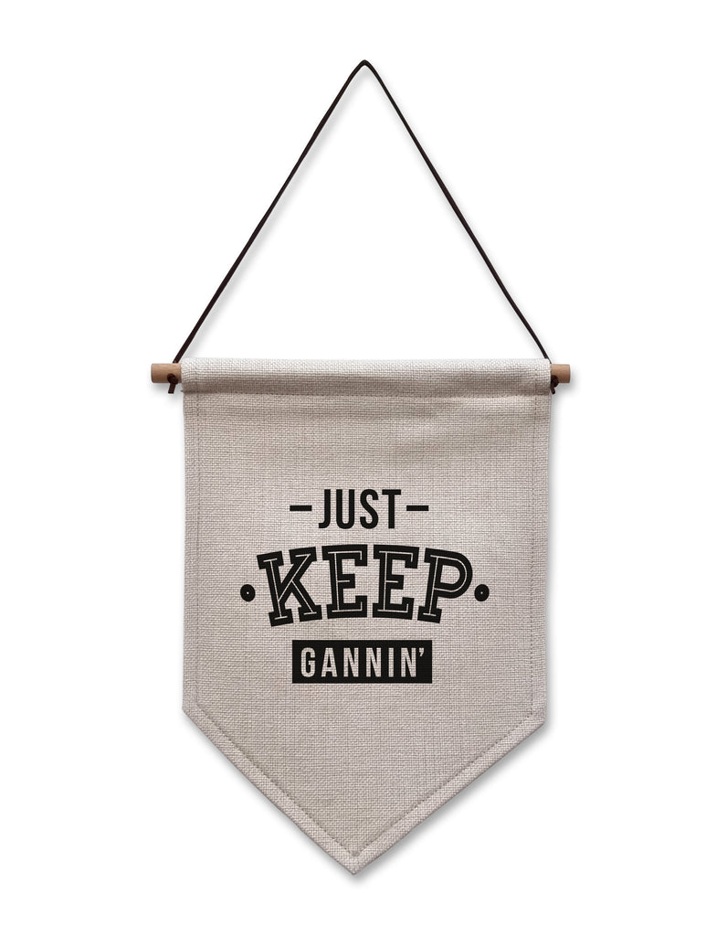 JUST KEEP GANNIN MOTIVATIONAL QUOTE GEORDIE AND NEWCASTLE ARTWORK HOMEWARE FOR A NORTHEAST HOUSE DECORATION. LINEN FLAG HANGING SIGN DESIGNED IN THE GRAINGER MARKET